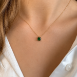 Emerald Pendant on Satin Blouse